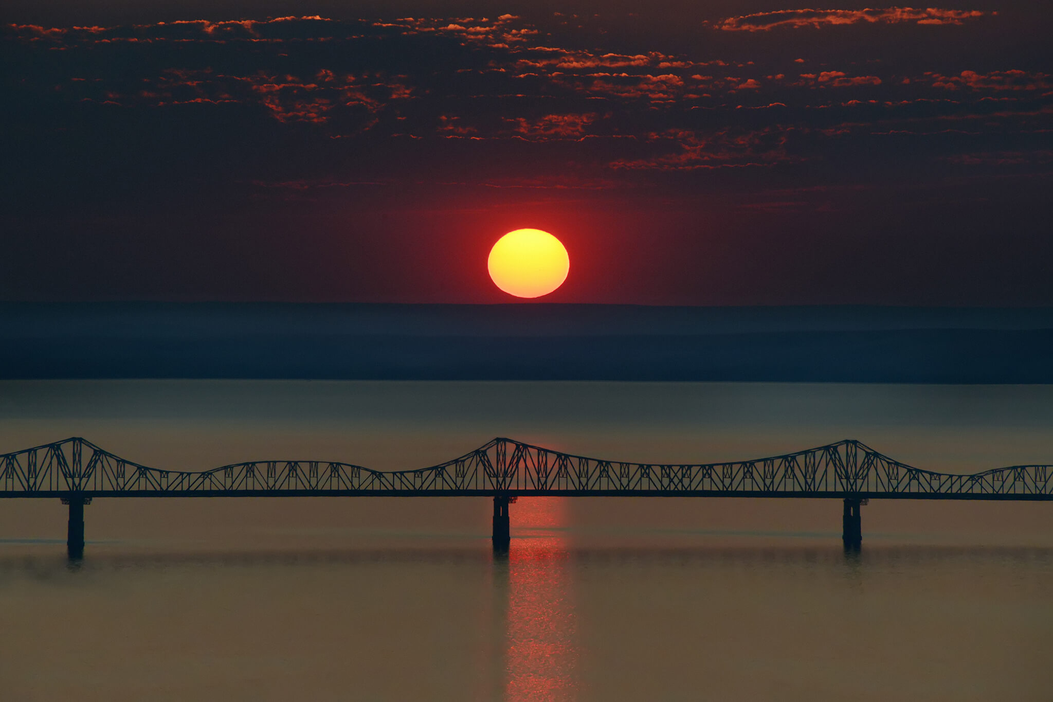 Sun setting over bridge