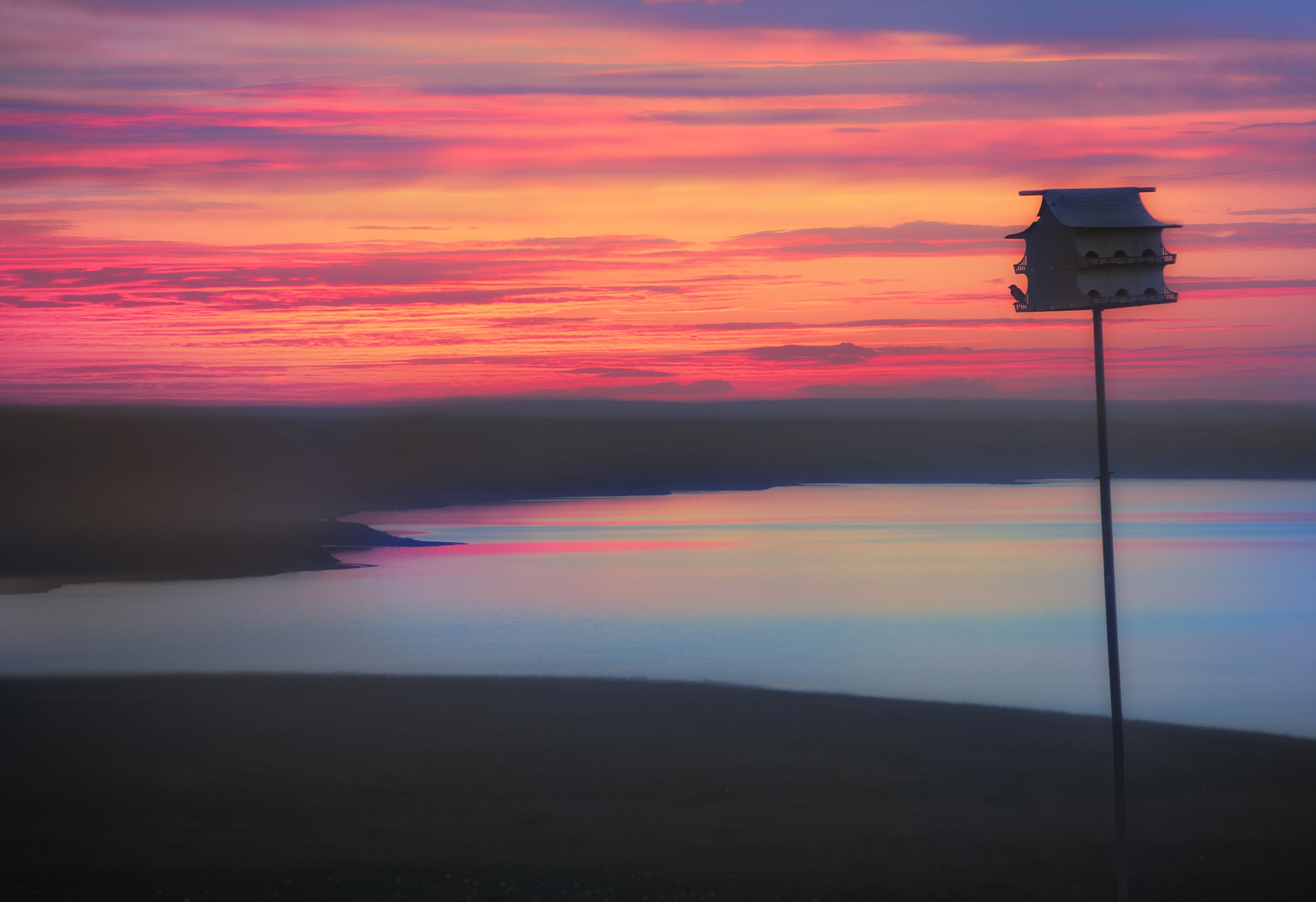 Colorful sunset and birdhouse picture