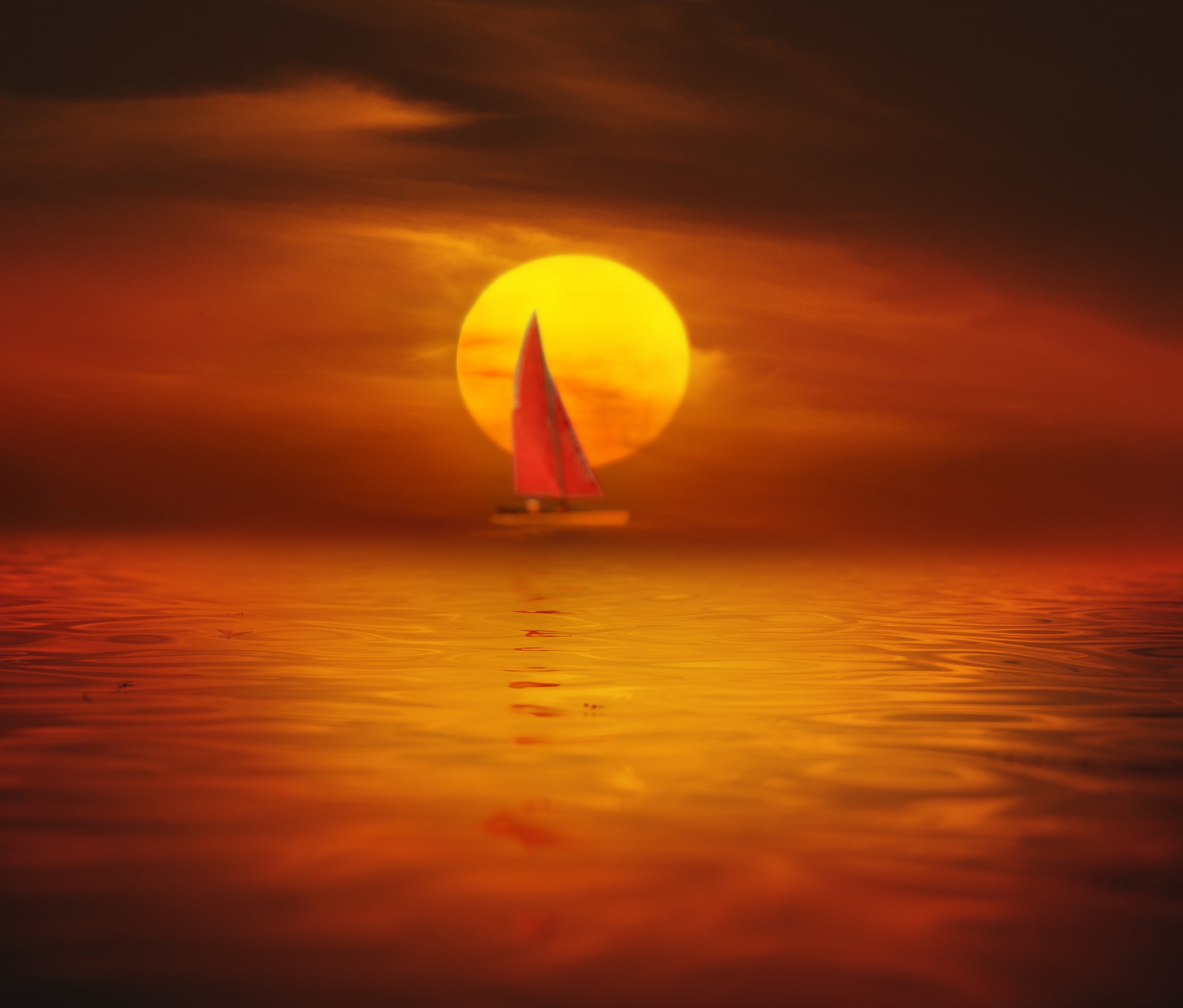 Red sailboat at sunset